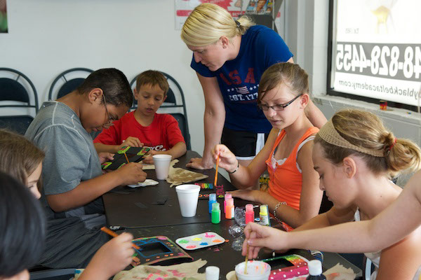 Children with staff doing crafts at Troy Aftyer School